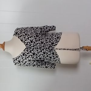 RUE21 BLACK TOP WITH WHITE FLOWERS, SIZE MEDIUM RUCHING AT NECK AND BOTTOM FRONT